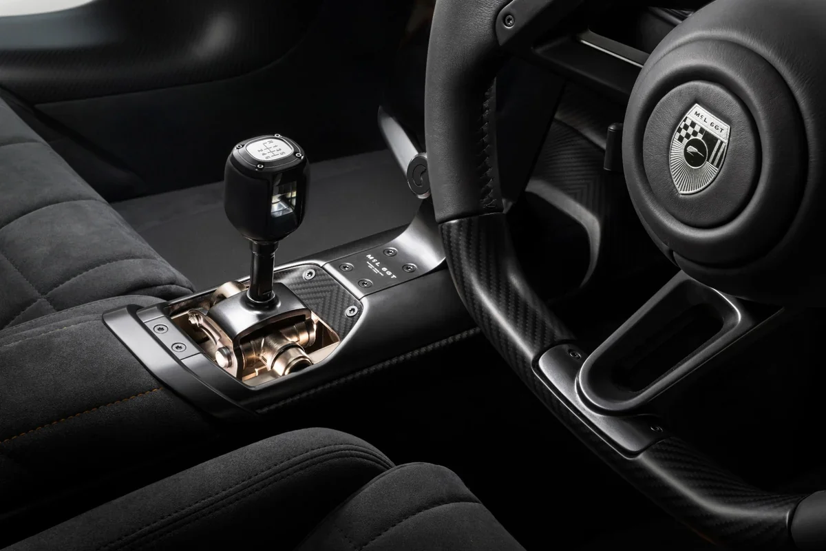 2028 McLaren McL 6GT cockpit with steering wheel and exposed manual shifter